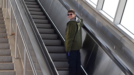 Elyse rides the escalator at Ashburn station