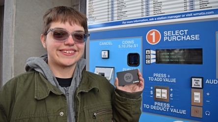 Elyse holds up a Silver Line SmarTrip card