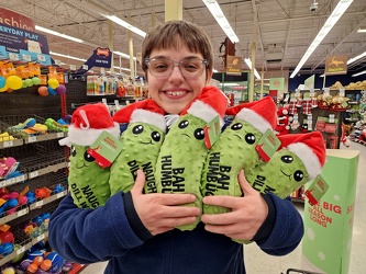 Elyse holds a handful of Christmas pickles