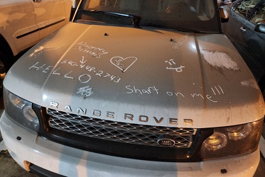 Abandoned vehicle in New Street parking garage with writing in the dirt [04]