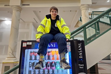 Elyse sits on top of a vending machine at Tanglewood Mall