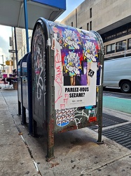 Mailbox covered with graffiti and stickers on 7th Avenue