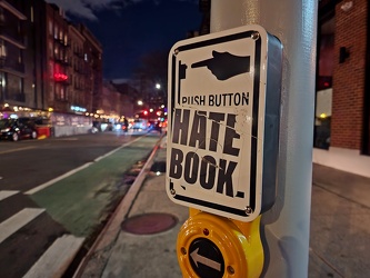 "HATE BOOK" sticker on pedestrian signal call button