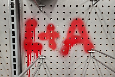 "L+A" spray painted on a pegboard