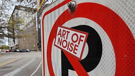 "Art of Noise" sticker on a no parking sign