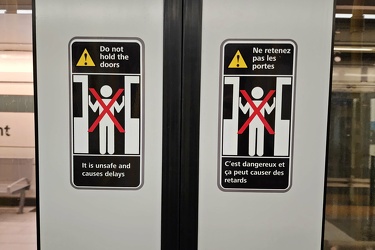 "Do not hold the doors" signage