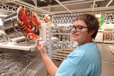 Elyse touches a crab at IKEA