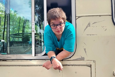 Elyse leans out of the window of former CARTA bus 3426