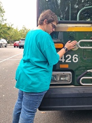 Elyse gives former CARTA bus 3426 a goodbye hug