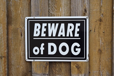 "Beware of dog" sign on a gate