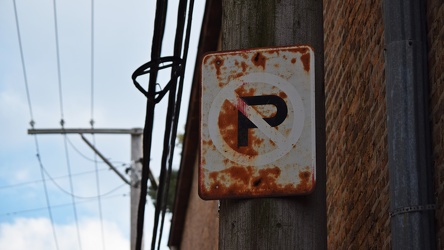 Rusted no parking sign in an alley [02]