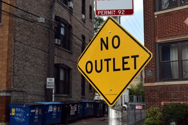 "NO OUTLET" sign at alley entrance