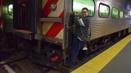 Elyse hangs from a train