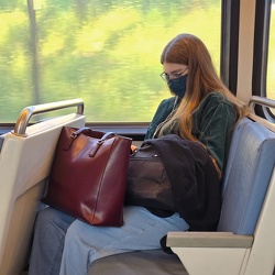 Woman looking at her phone on the Metro [01]