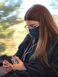 Woman looking at her phone on the Metro [03]