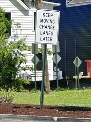 Sign advising motorists to change lanes later