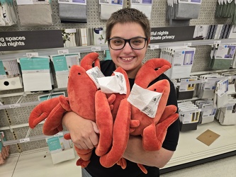 Elyse holds several lobster pillows