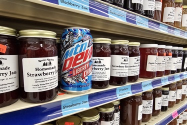 Can of Mountain Dew amongst the jars of jam