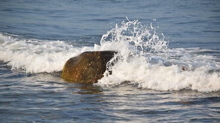 Wave crashing around a boulder at Montauk Point [03]